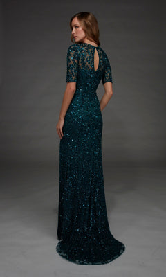 Wearing the Alyce 27901 long formal dress, a woman stands in a dark green, floor-length gown featuring short lace sleeves and a keyhole back. The fitted column silhouette is beautifully embellished with beading and sequins as she faces away, turning her head slightly toward the camera.
