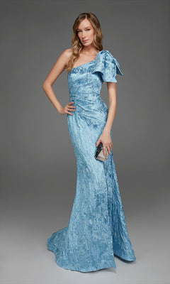 A woman wearing the Alyce 27906 long formal dress, featuring a one-shoulder neckline and a floor-length light blue design, holds a small metallic clutch while posing against a plain gray background.