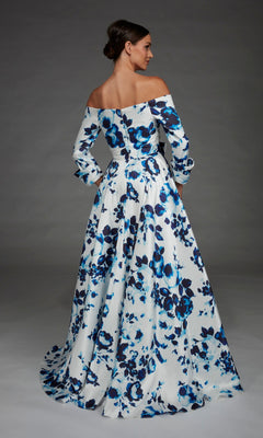 A woman stands with her back to the camera, wearing the Alyce 27910 long formal dress—an off-the-shoulder evening gown with long sleeves and a blue and white floral pattern.