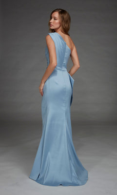 A woman stands against a plain gray background, looking over her shoulder, wearing the Alyce 27913 long formal dress in light blue satin with an elegant one-shoulder neckline.