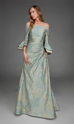 Wearing the Alyce 27914 long formal dress in celadon, a woman stands against a plain gray background. The textured, off-the-shoulder gown features flared sleeves and an A-line silhouette, while its metallic jacquard fabric adds subtle shimmer to the sophisticated look.
