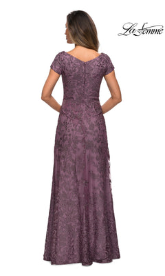 A woman faces away, wearing Long Formal Dress: La Femme 27915—a mauve, floor-length lace gown with floral embroidery. The La Femme logo appears top right.