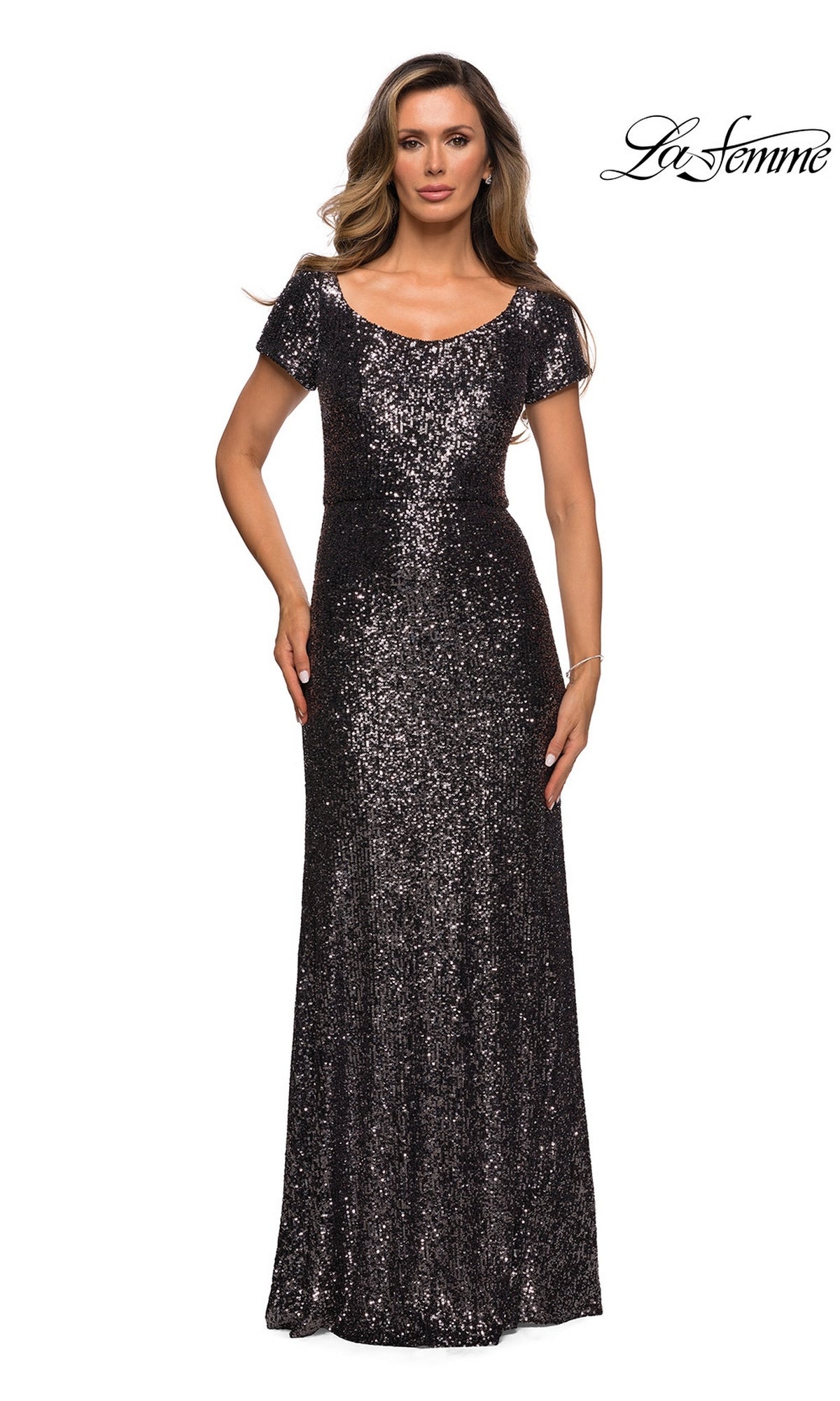 A woman wearing a floor-length, short-sleeved gunmetal sequin La Femme 27916 formal dress with a scoop neckline.