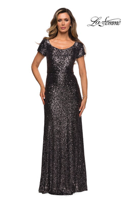A woman wearing a floor-length, short-sleeved gunmetal sequin La Femme 27916 formal dress with a scoop neckline.