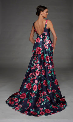 A woman poses against a plain gray background wearing the Alyce 27917 long formal dress, a sleeveless, floor-length navy gown with a v-neckline, deep V-back, pink floral print, and an elegant train.