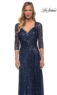 Woman wearing Long Formal Dress: La Femme 27930—navy blue sequin, three-quarter sleeves, v-neckline, fitted bodice—standing against a white background.