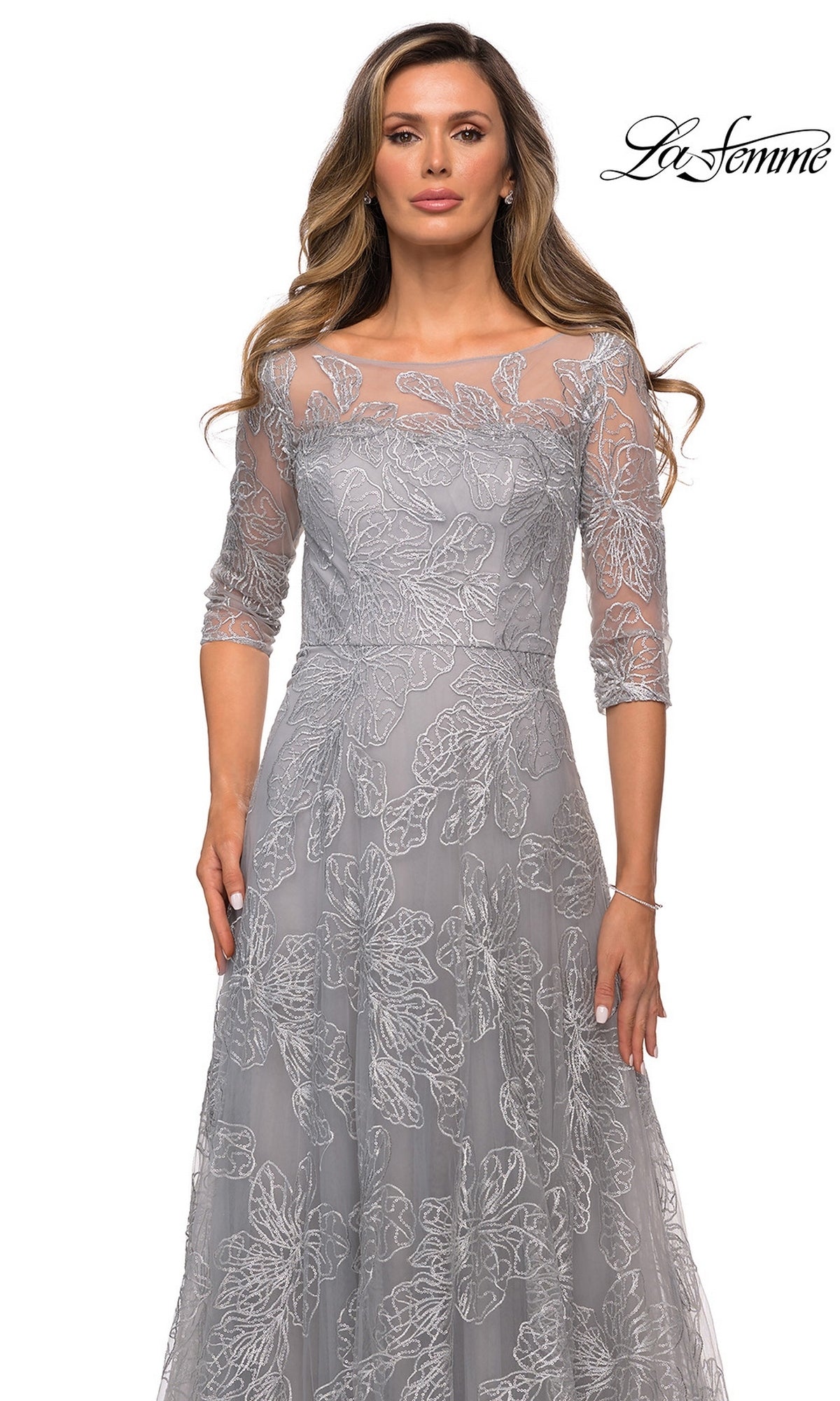Woman in a Long Formal Dress: La Femme 27942—grey lace dress with three-quarter sleeves and floral embroidery, set against a plain white background.