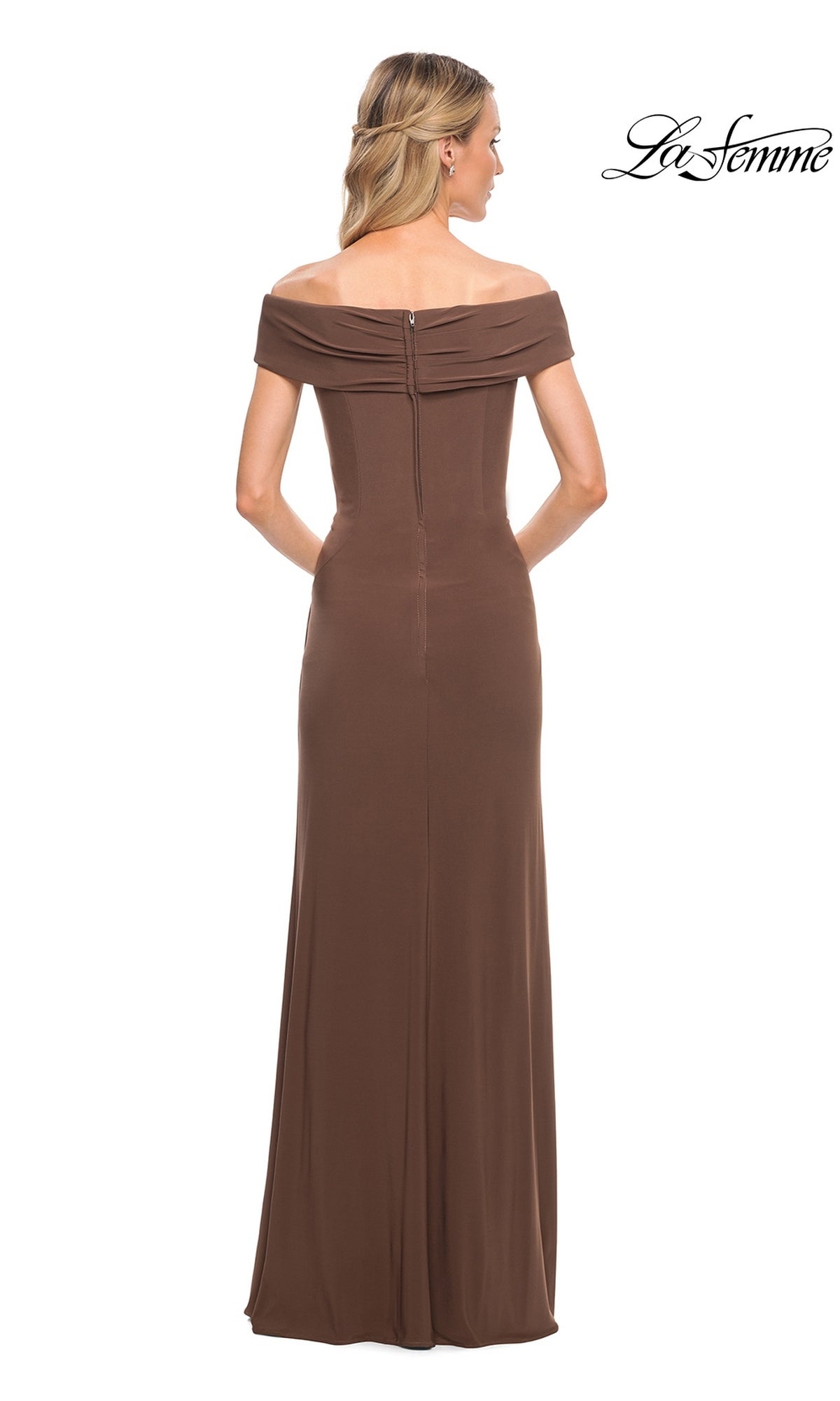 Woman wearing the Long Formal Dress: La Femme 27959, a brown, off-the-shoulder jersey gown, floor-length, shown from the back with her hair half pulled back.
