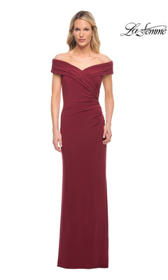 A woman wears the Long Formal Dress: La Femme 27959 in wine, featuring off-the-shoulder style, floor length, ruched details, and a fitted silhouette. The La Femme logo is in the top right.