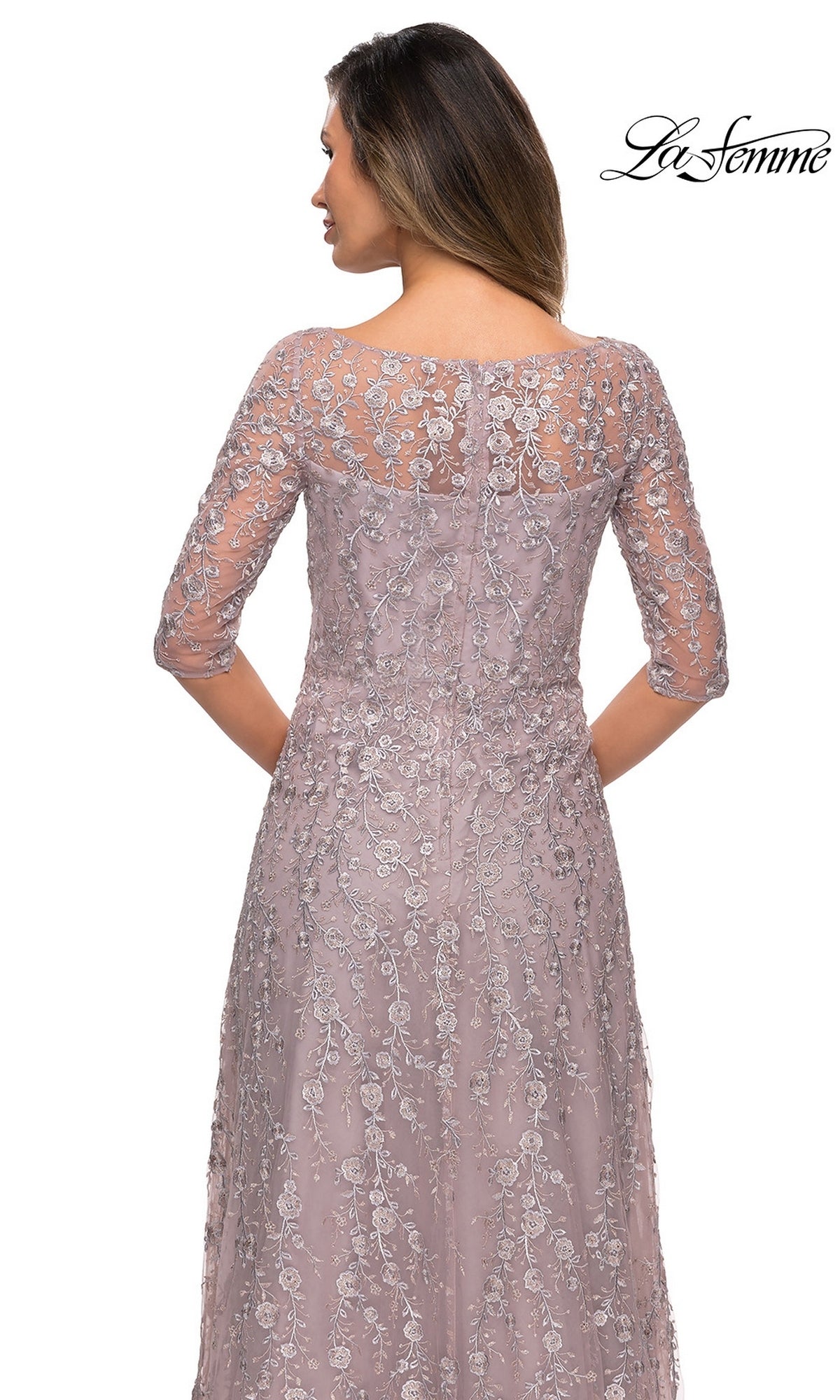Woman facing away in a mauve lace Long Formal Dress: La Femme 27981 with three-quarter sleeves and floral embroidery. La Femme logo in the top right corner.