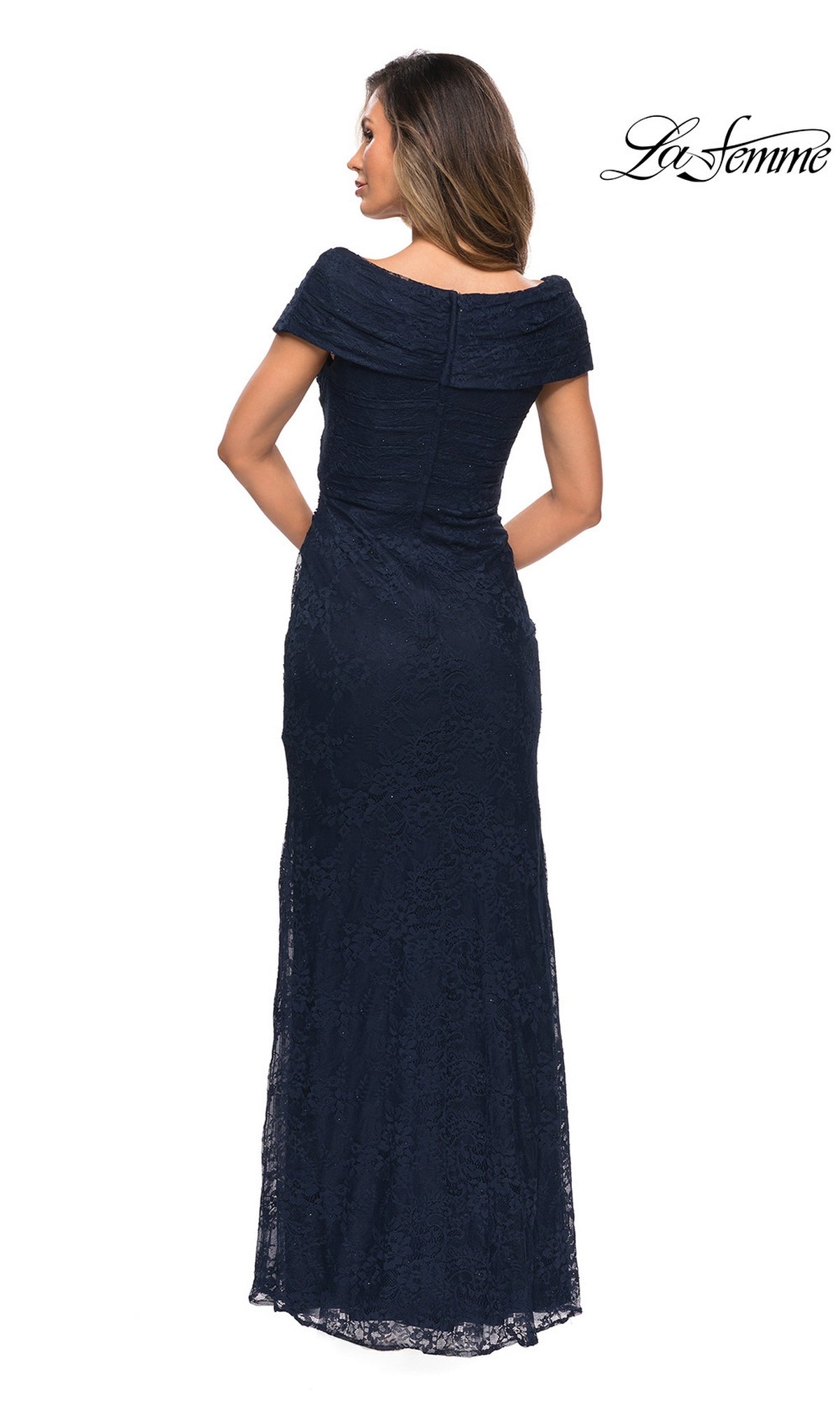 A woman is shown from the back wearing the La Femme 27982 long formal dress, an off-the-shoulder, floor-length navy lace mother of the bride gown. The “La Femme” logo appears in the top right corner.