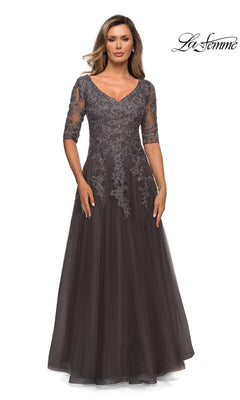 A woman wearing a gunmetal-colored La Femme 27993 A-line formal dress with three-quarter floral lace sleeves and a V-neckline.