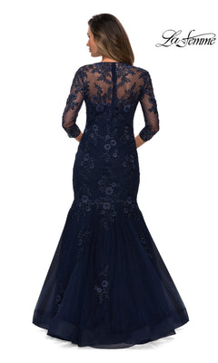 Woman in the Long Formal Dress: La Femme 28033—navy blue floral lace with sheer sleeves, embroidery, and a mermaid silhouette—shown from the back.