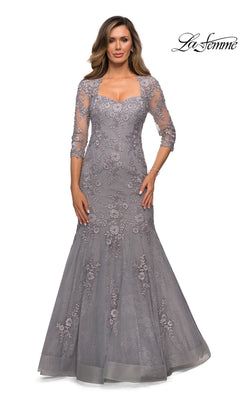 Woman wearing the Long Formal Dress: La Femme 28033 in silver with three-quarter sleeves and floral lace, standing against a white background.