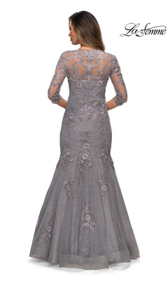Woman in Long Formal Dress: La Femme 28033 with grey floral lace, embroidery, sheer back, and 3/4 sleeves; “La Femme” logo at top right.