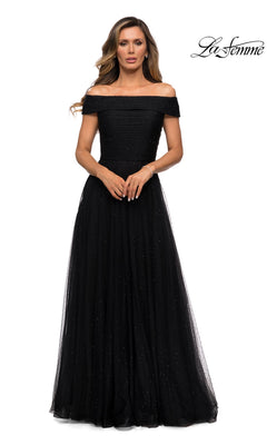 Woman in a black, off-the-shoulder Long Formal Dress: La Femme 28051 with glitter and fitted bodice, standing forward with hands clasped. “La Femme” logo top right.