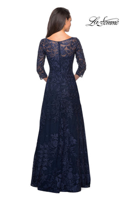 Woman shown from the back wearing the Long Formal Dress: La Femme 28053—navy blue, floor-length, embroidered, with three-quarter sleeves.
