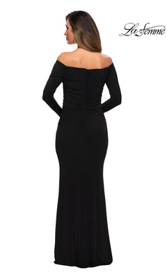 Woman facing away, wearing Long Formal Dress: La Femme 28054—a black off-the-shoulder fitted jersey sheath. Hair is down. “La Femme” logo appears in the top right corner.