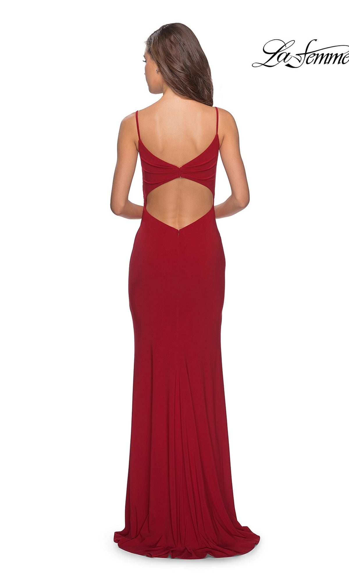 A woman is seen from behind wearing the La Femme 28079 long prom dress—a fitted red jersey gown with thin straps, a dramatic lower back cutout, and a thigh-high slit. The “La Femme” logo appears in the upper right corner.