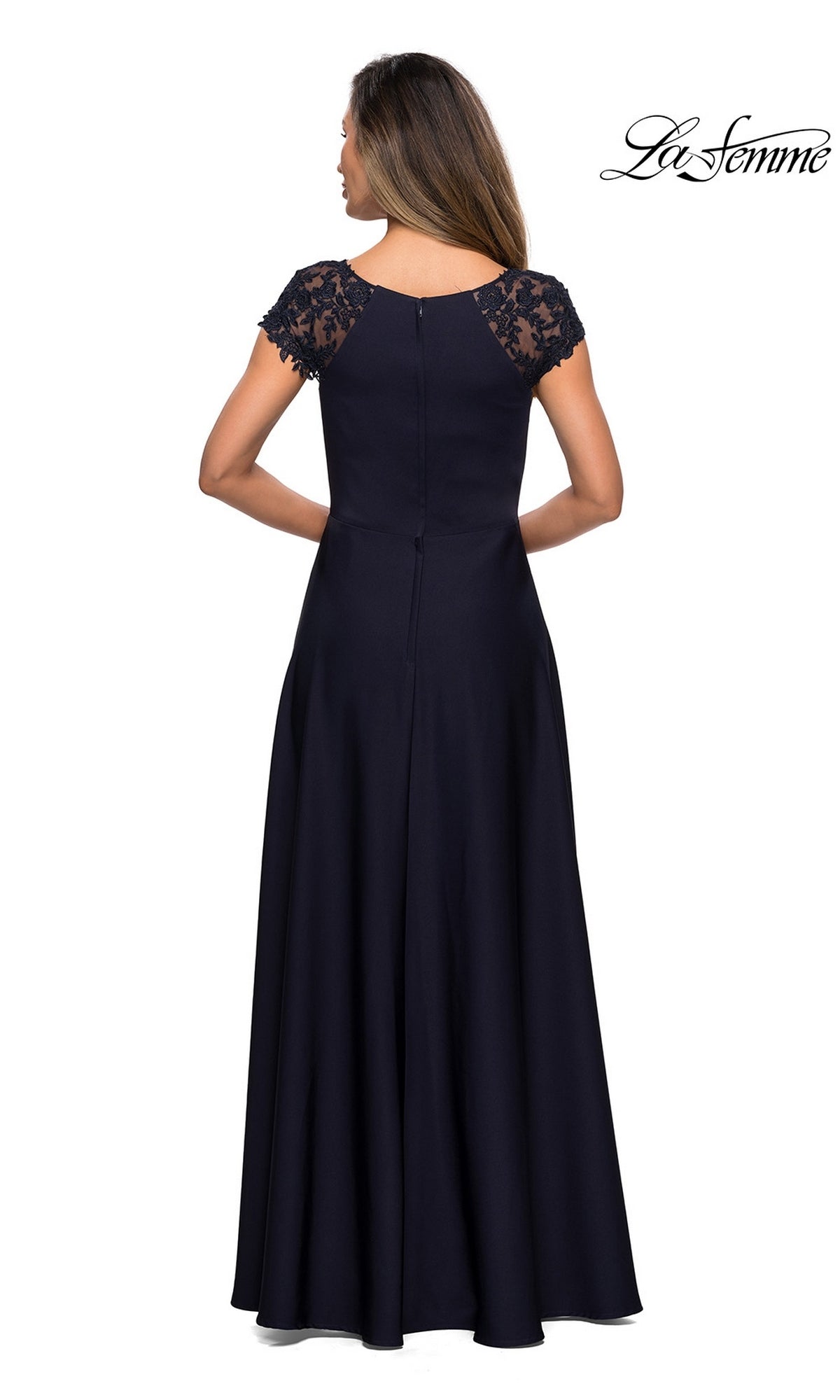 A woman is pictured from behind wearing the Long Formal Dress: La Femme 28100, a modest navy blue gown featuring lace cap sleeves and a graceful A-line silhouette; the “La Femme” logo appears in the top right corner.