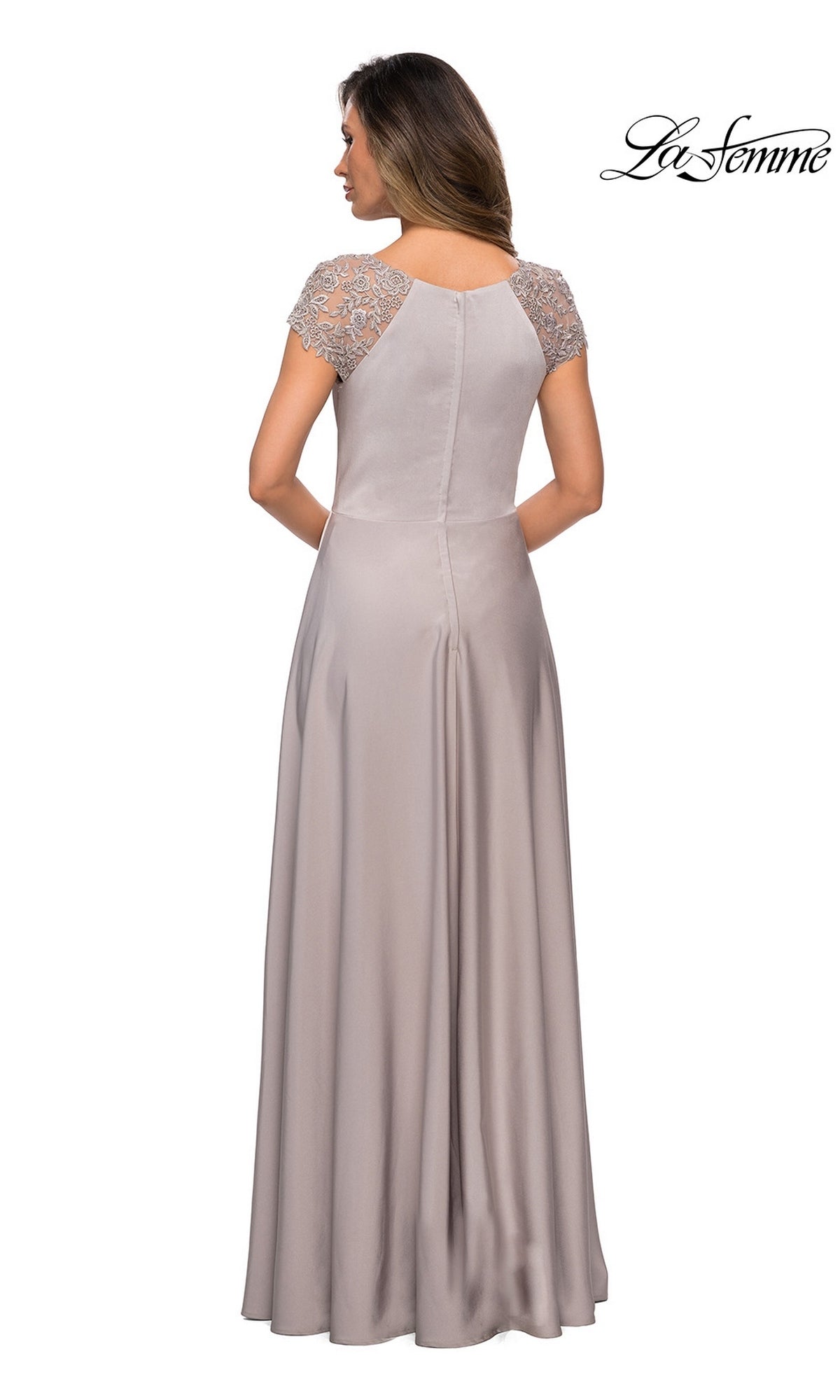 A woman is seen from the back wearing the Long Formal Dress: La Femme 28100, a floor-length light lavender gown with short lace-detailed sleeves and an elegant A-line silhouette.