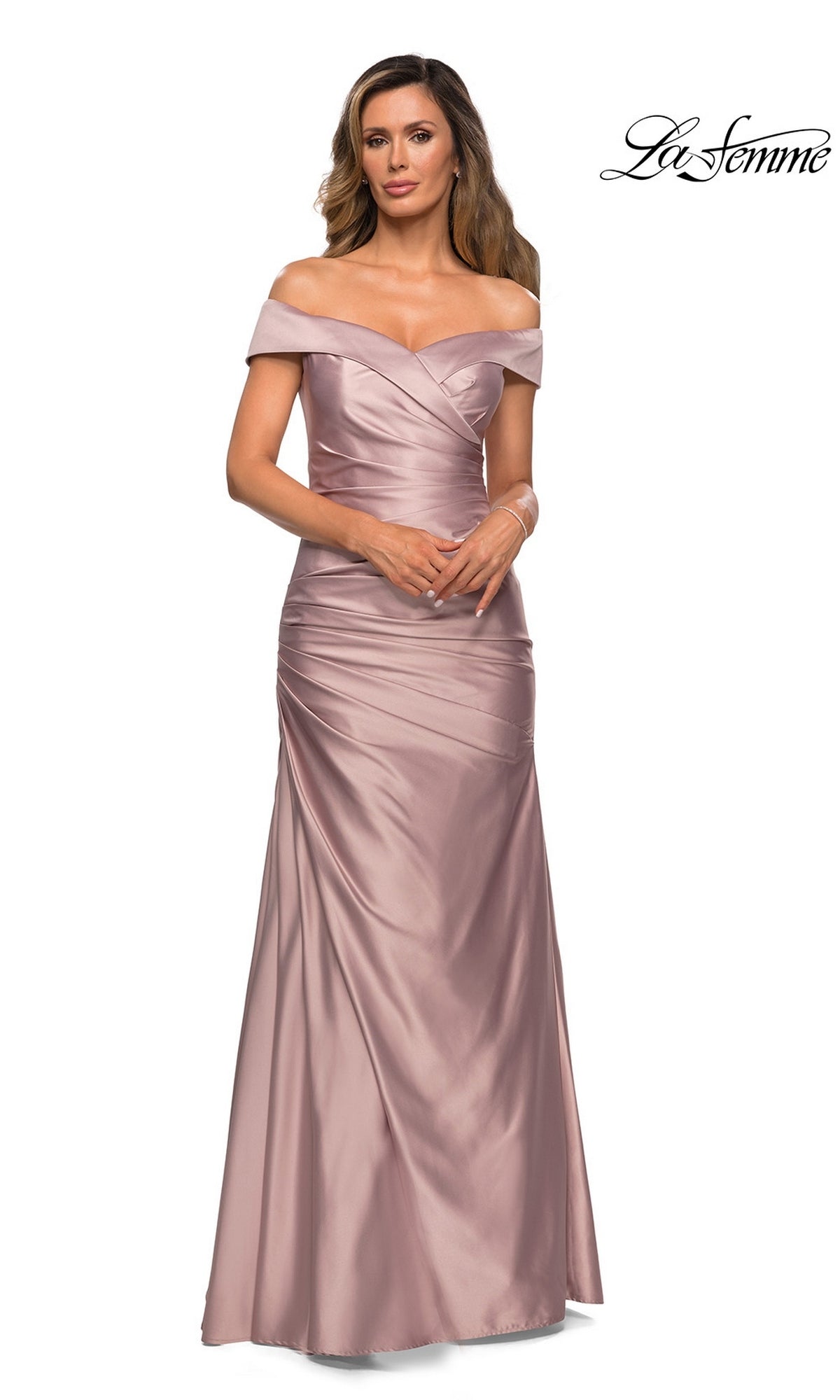 Woman wearing the La Femme 28103 long formal dress in champagne, featuring an off-the-shoulder neckline, fitted bodice, and flared skirt—an elegant mother-of-the-bride choice—standing against a plain white background.