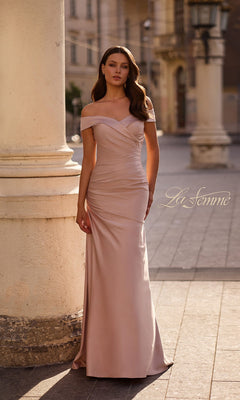 A woman in a pink champagne off-the-shoulder gown, the Long Formal Dress: La Femme 28103—ideal for a mother-of-the-bride—stands outdoors near columns, with the “La Femme” logo displayed on the image.