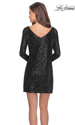 A woman models the Short Sequin Party Dress: La Femme 28194, featuring long sleeves and a dramatic v-back, as she stands facing away from the camera. The La Femme logo is displayed in the top right corner.