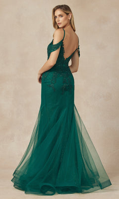 A woman wears the Juliet 281 Long Glitter Mermaid Prom Dress in emerald green, featuring off-the-shoulder lace details and a sheer tulle skirt, as she stands facing away and looks over her shoulder.
