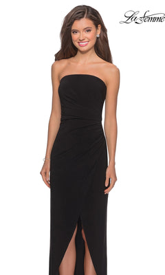 Woman wearing the Long Prom Dress: La Femme 28204 with a strapless ruched bodice, sheath skirt, and front slit, smiling against a white background.