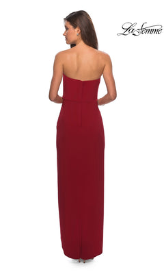 Woman facing away in Long Prom Dress: La Femme 28204, a strapless gown with ruched bodice and sheath skirt, against white background with “La Femme” logo.