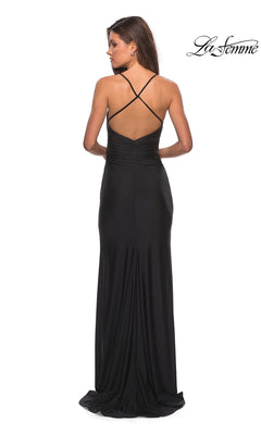 Woman wearing the La Femme Open-Back Long V-Neck Prom Dress 28206, featuring a fitted waist and crisscross straps on an open back, standing against a white background.
