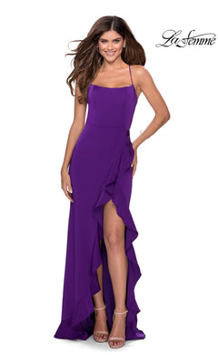 A woman smiles in a floor-length, sleeveless purple La Femme Side-Ruffle Long Prom Dress 28294, featuring a ruffled high slit, against a white background. The "La Femme" logo appears in the top right corner.