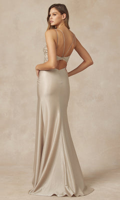 A woman in the Embroidered-Sheer-Bodice Tight Long Prom Dress 282, featuring a fitted champagne silhouette, floor-length hem, strappy open back, and embroidered bodice, stands facing away and looks over her shoulder.