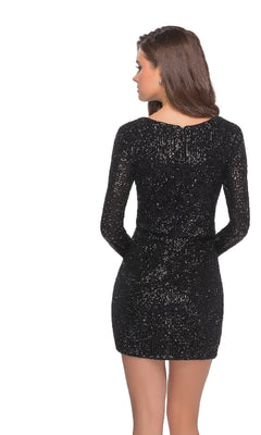 A woman with long brown hair stands with her back to the camera, showcasing the Long Sleeve Sequin Cocktail Dress: La Femme 28316 in black.