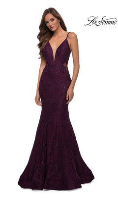 A woman wears the La Femme Backless Long Lace Prom Dress 28355 in deep purple, featuring a floor-length mermaid skirt, plunging neckline, thin straps, and elegant lace detailing.