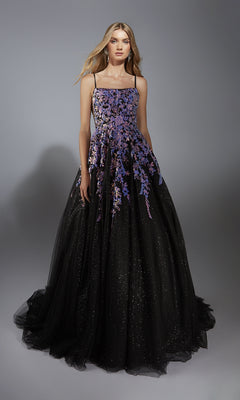 A woman poses against a plain gray background wearing the Long Formal Dress: Aerie Couture 283, featuring an a-line glitter tulle skirt, floral embellishments, and thin straps.