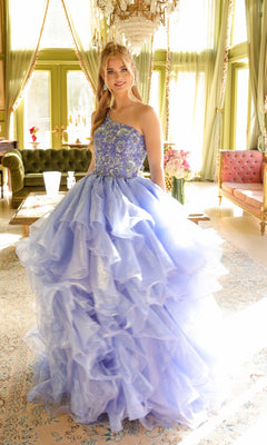 A young woman stands on a patterned rug near a chandelier, wearing the Ava Presley 28575 one-shoulder prom ball gown with light purple ruffles in an elegant room.
