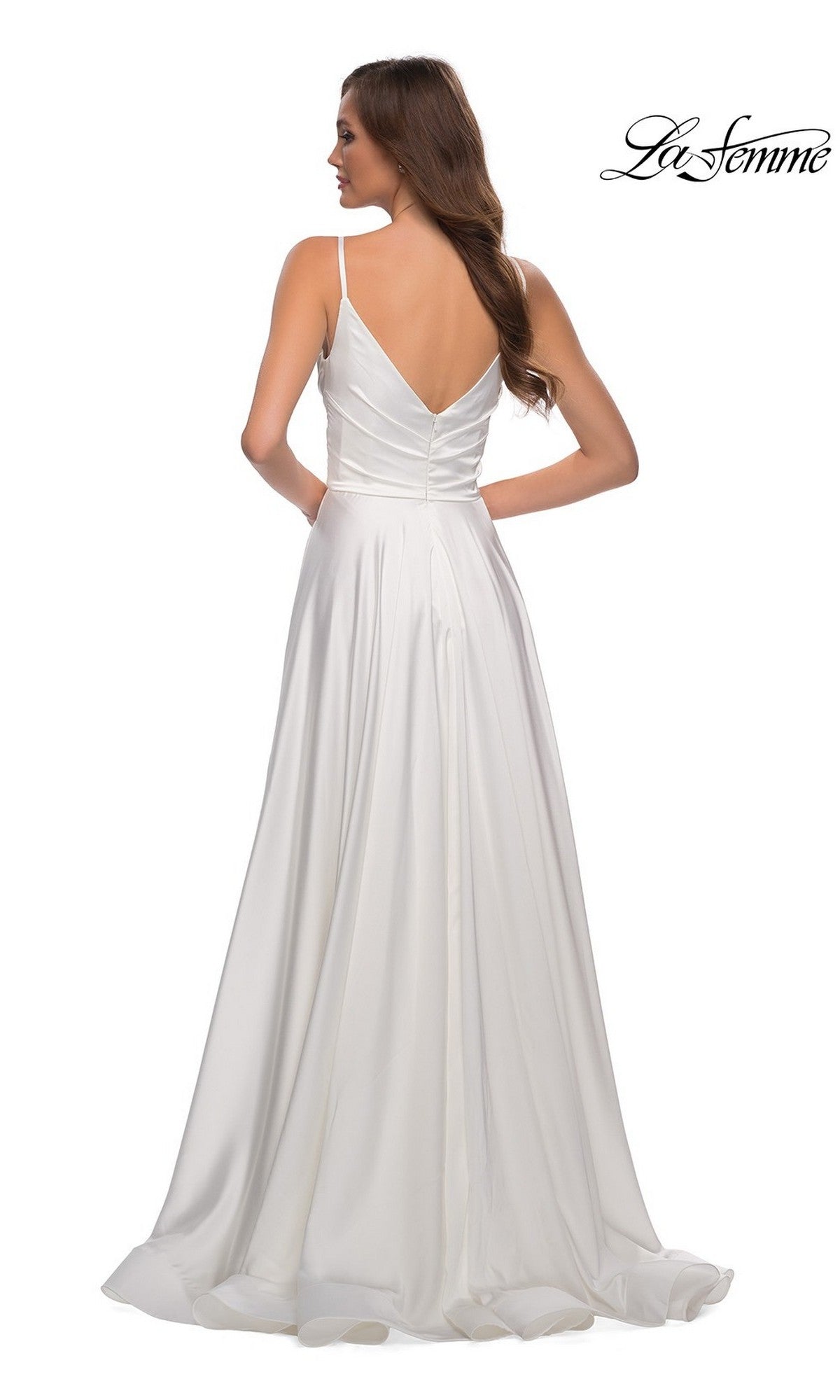 A woman faces away from the camera in the La Femme V-Neck Long A-Line Prom Dress 28607, featuring white satin, thin straps, and a V-back. The La Femme 28607 logo is displayed in the top right corner.