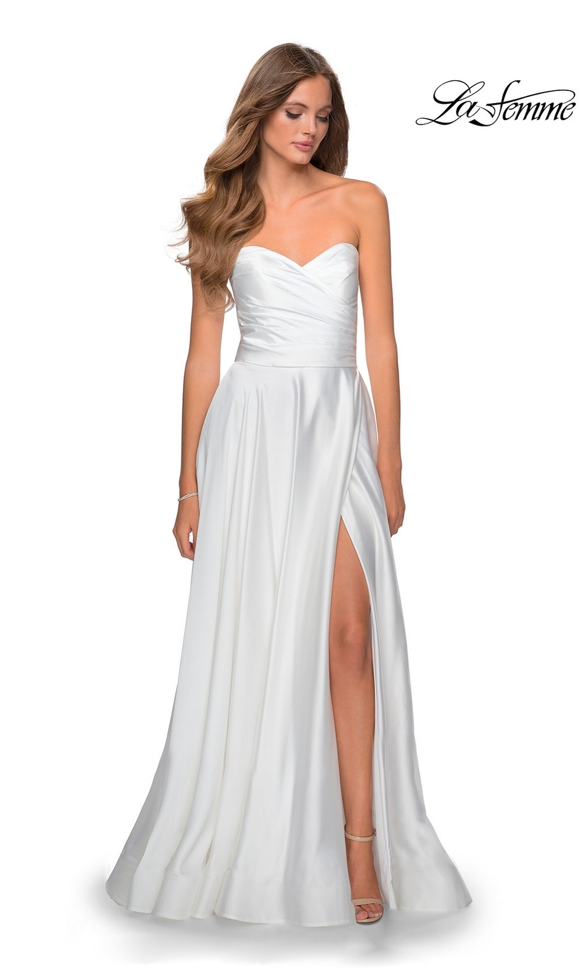 A woman wears the La Femme Strapless Long A-Line Prom Dress 28608, featuring a sweetheart neckline, fitted bodice, and thigh-high slit. The flowing skirt and elegant design make this formal gown perfect for prom or special occasions.