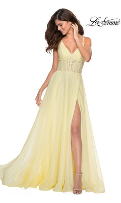 Woman wearing the La Femme Sheer-Lace-Bodice Long Prom Dress 28664 in light yellow with spaghetti straps and a high slit, posing against a white background.