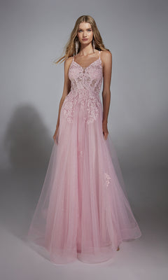 A woman stands against a plain gray background wearing the Aerie Couture 286 Glitter Tulle Prom Ball Gown, a long, sleeveless dress in light pink with lace embroidery and tulle details.