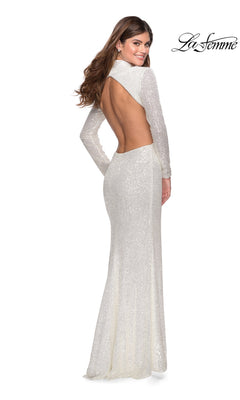 Woman in the Long Prom Dress: La Femme 28771, smiling over her shoulder in a long sleeve sequin gown with open back. “La Femme” logo in upper right corner.
