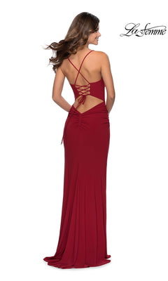 Back view of a floor-length red jersey La Femme 28792 prom dress featuring a lace-up open back and thin straps.