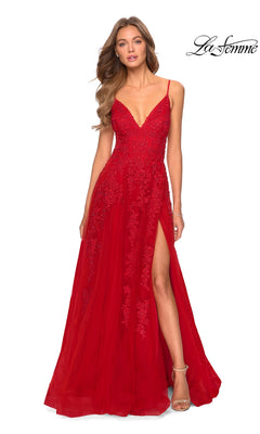 A woman models the Strappy-Back Long Prom Dress: La Femme 28985—a long red gown with lace detailing, beaded embroidery, spaghetti straps, a deep V-neckline, and a high side slit—against a white background.