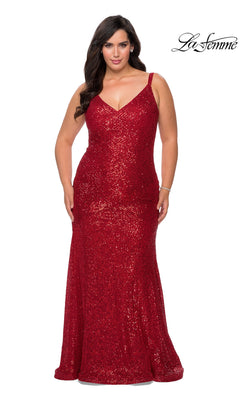 A plus-size person wearing a red, floor-length La Femme 29006 sequin prom dress with a V-neckline and spaghetti straps.