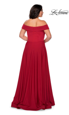 Woman in a red, off-the-shoulder, floor-length Long Plus-Size Prom Dress: La Femme 29007, facing away with the La Femme logo in the top right corner.