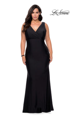 A plus-size person wearing a black Long Plus-Size Prom Dress: La Femme 29016, a floor-length faux wrap-style evening gown with a V-neckline.