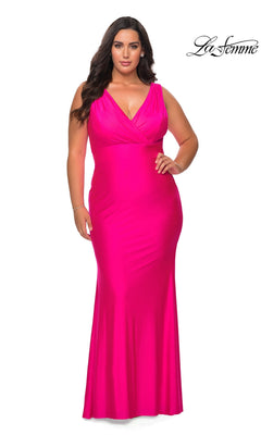 A plus-size person wearing a neon pink, floor-length V-neck Long Plus-Size Prom Dress: La Femme 29016.