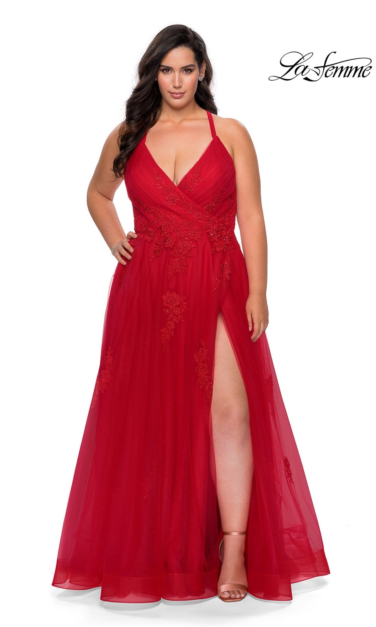 A woman poses in front of a white background wearing the La Femme Long Prom Dress 29021, a sleeveless red formal evening gown featuring floral embroidery and a high slit. The “La Femme” logo appears in the top right corner.